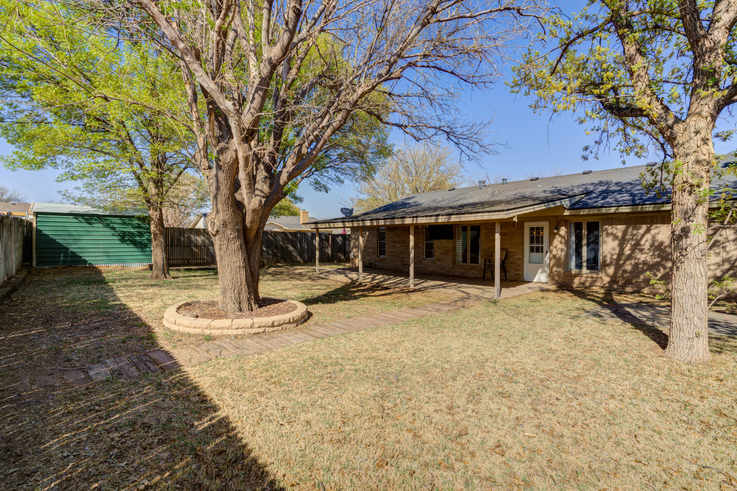 7106 Zoar Avenue Lubbock, TX 79424 - Photo 31 of 33 a front view of a house with a yard and a tree
