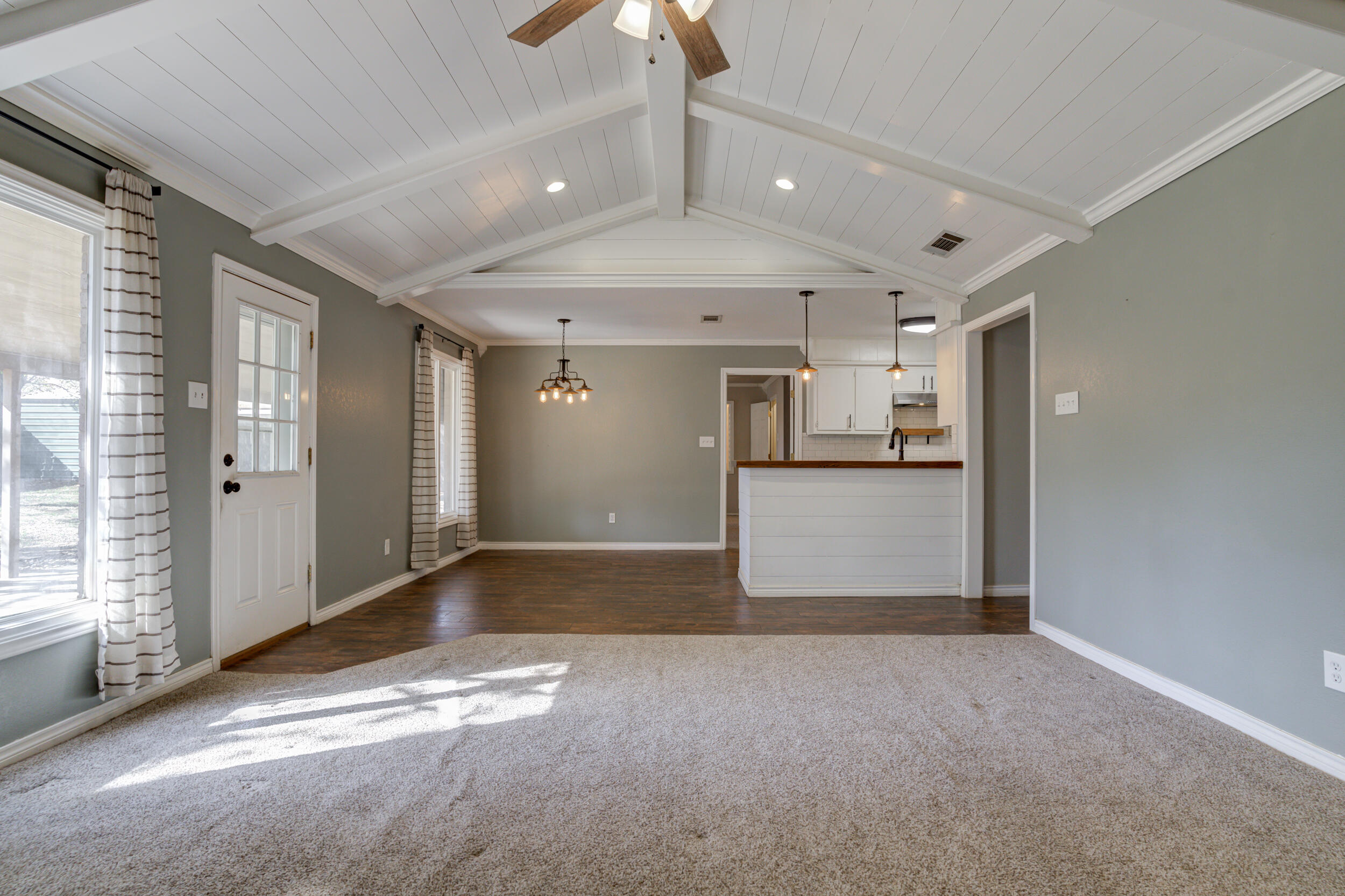 7106 Zoar Avenue Lubbock, TX 79424 - Photo 8 of 33 a view of a hallway with wooden floor and a kitchen