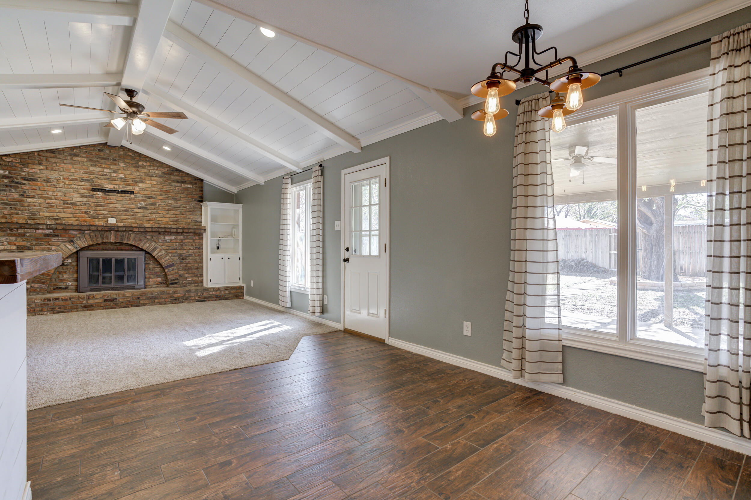 7106 Zoar Avenue Lubbock, TX 79424 - Photo 9 of 33 a view of empty room with fireplace and wooden floor