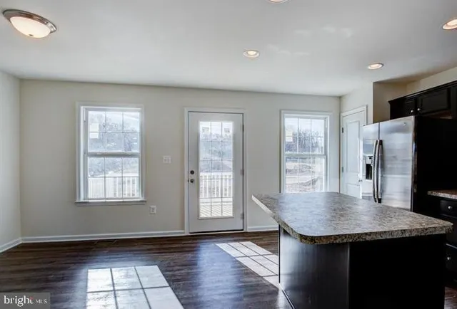 an empty room with window and wooden floor