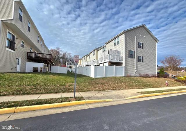 a view of the house with a yard and large tree