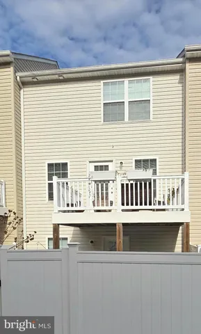 a view of a kitchen with stainless steel appliances a sink and cabinets