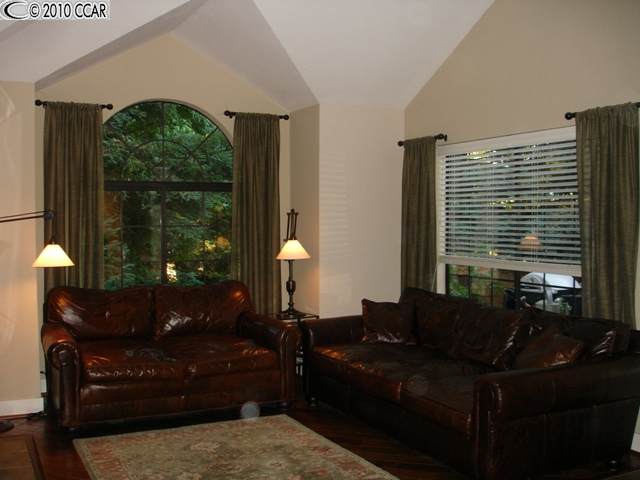 234 Copper Ridge Road, Unit 104 San Ramon, CA 94582 - Photo 1 of 1 a living room with furniture and a floor to ceiling window