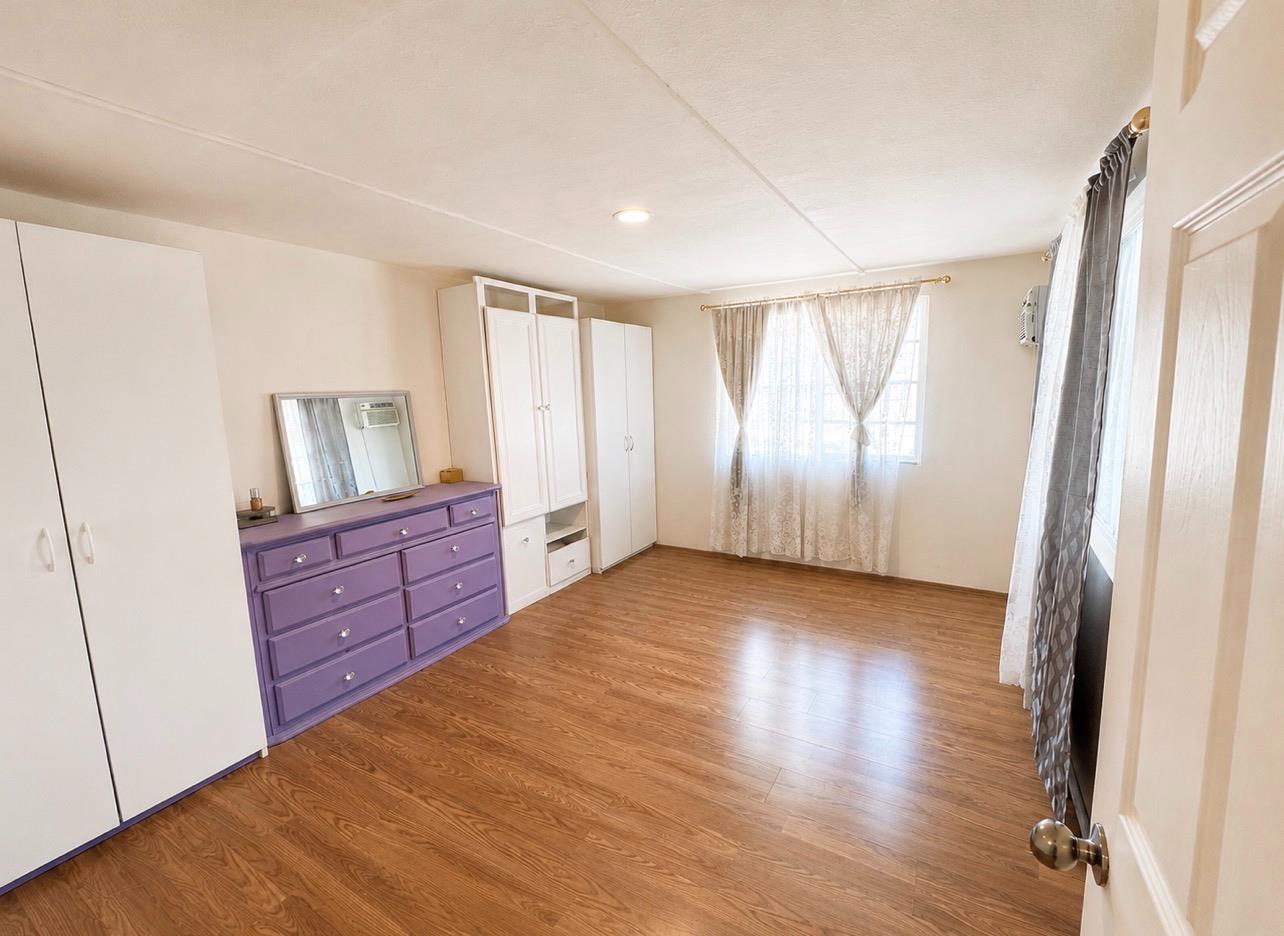 5000 Pierce Road, Unit 32 Bakersfield, CA 93308 - Photo 3 of 15 a view of room with window and wooden floor