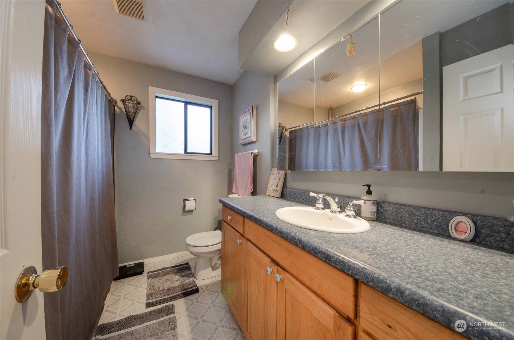 10430 Highway 12 Rochester, WA 98579 - Photo 14 of 36 a bathroom with a granite countertop sink a toilet and a mirror