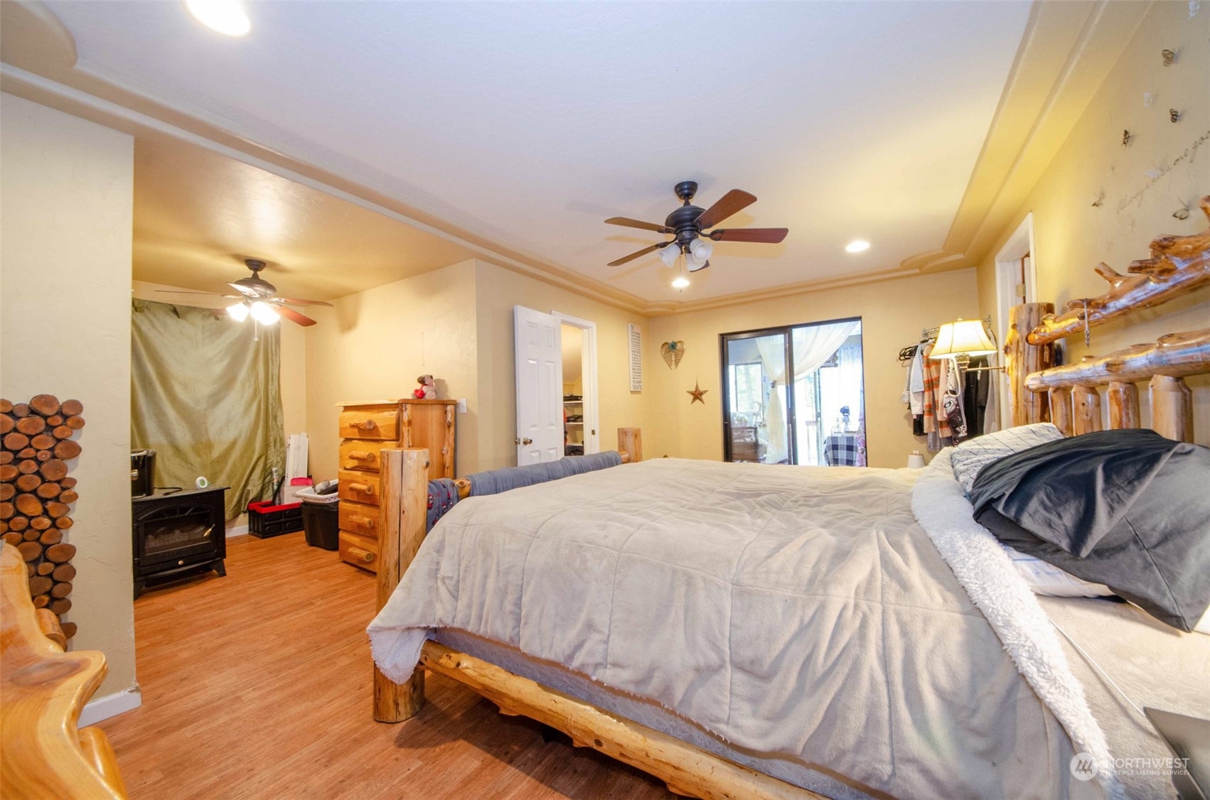 10430 Highway 12 Rochester, WA 98579 - Photo 17 of 36 a spacious bedroom with a bed a ceiling fan and a dresser
