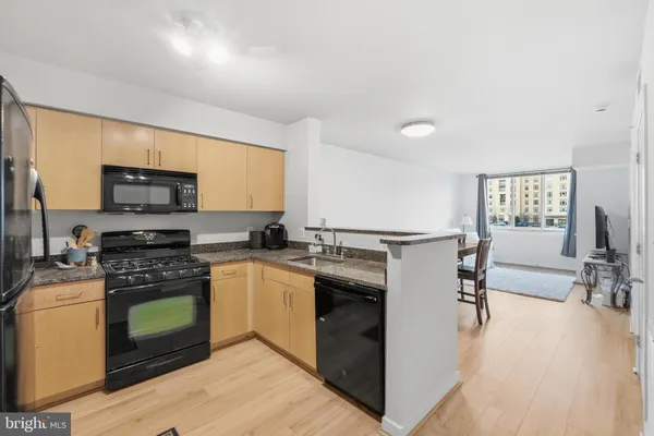 a kitchen with a stove a sink and a microwave