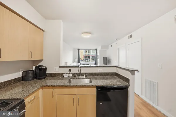 a kitchen with granite countertop a sink and cabinets