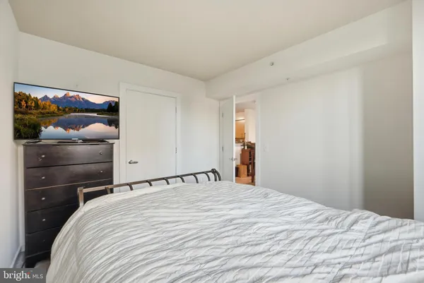 a bedroom with a bed and a mirror