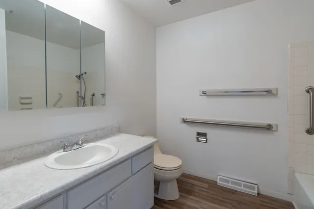 a bathroom with a toilet sink and mirror