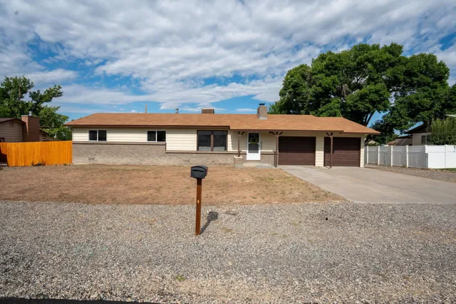 a front view of a house with a yard garage and outdoor seating