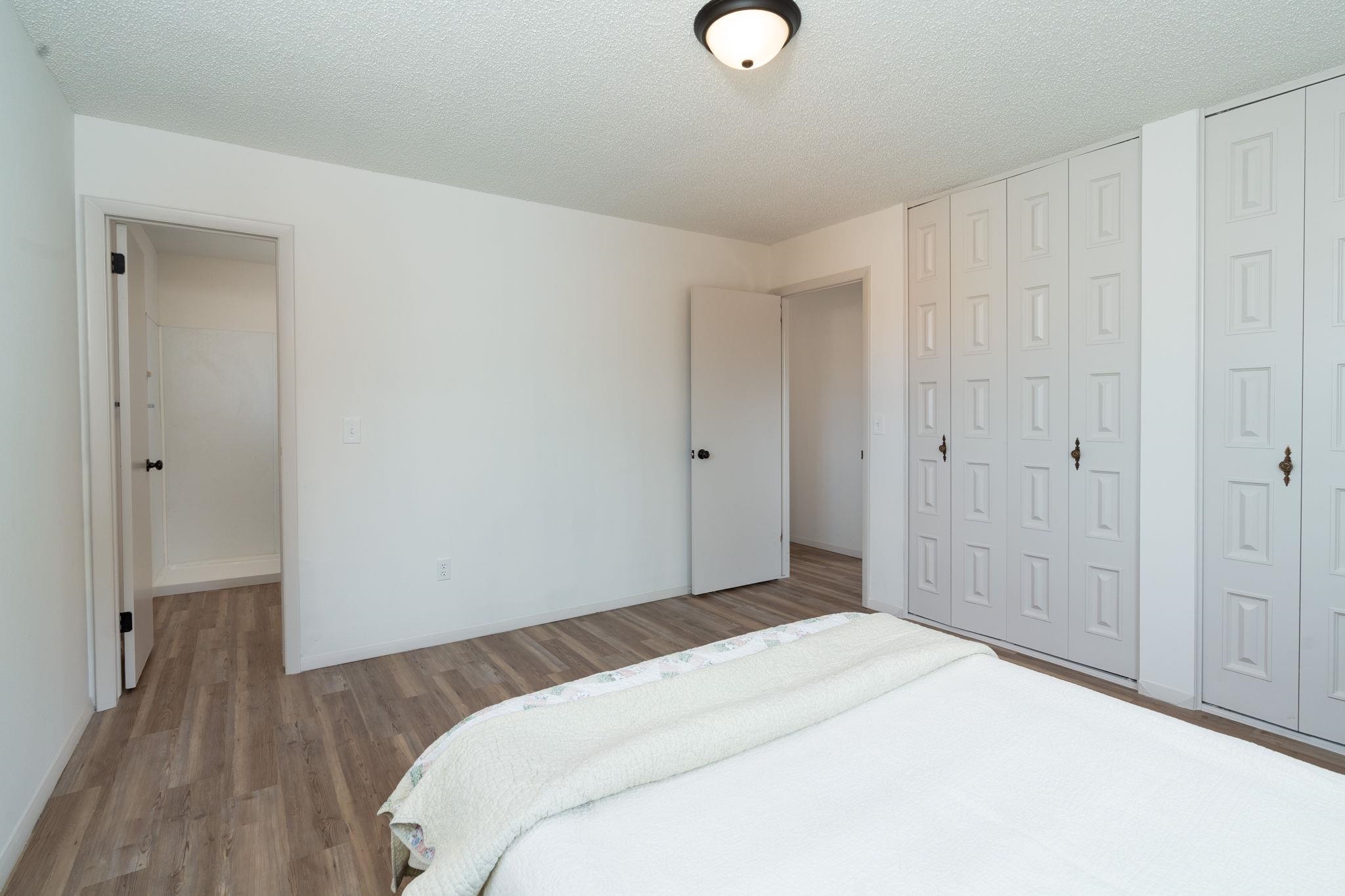543 Dodge Street Grand Junction, CO 81504 - Photo 8 of 19 a bedroom with a bed and a chandelier