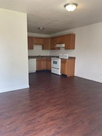 a large kitchen with stainless steel appliances granite countertop a stove a sink and a refrigerator