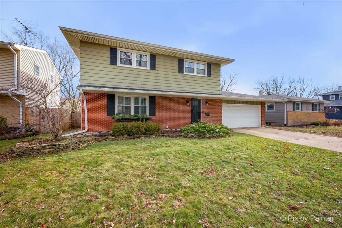 152 Walnut Drive St. Charles, IL 60174 - Photo 2 of 30 a front view of house with yard and trees