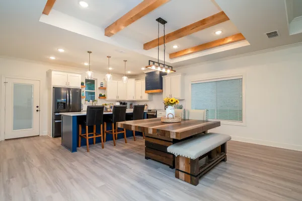 a living room with lots of furniture and kitchen view