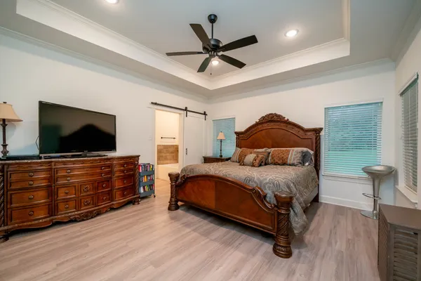 a bedroom with a bed and flat screen tv