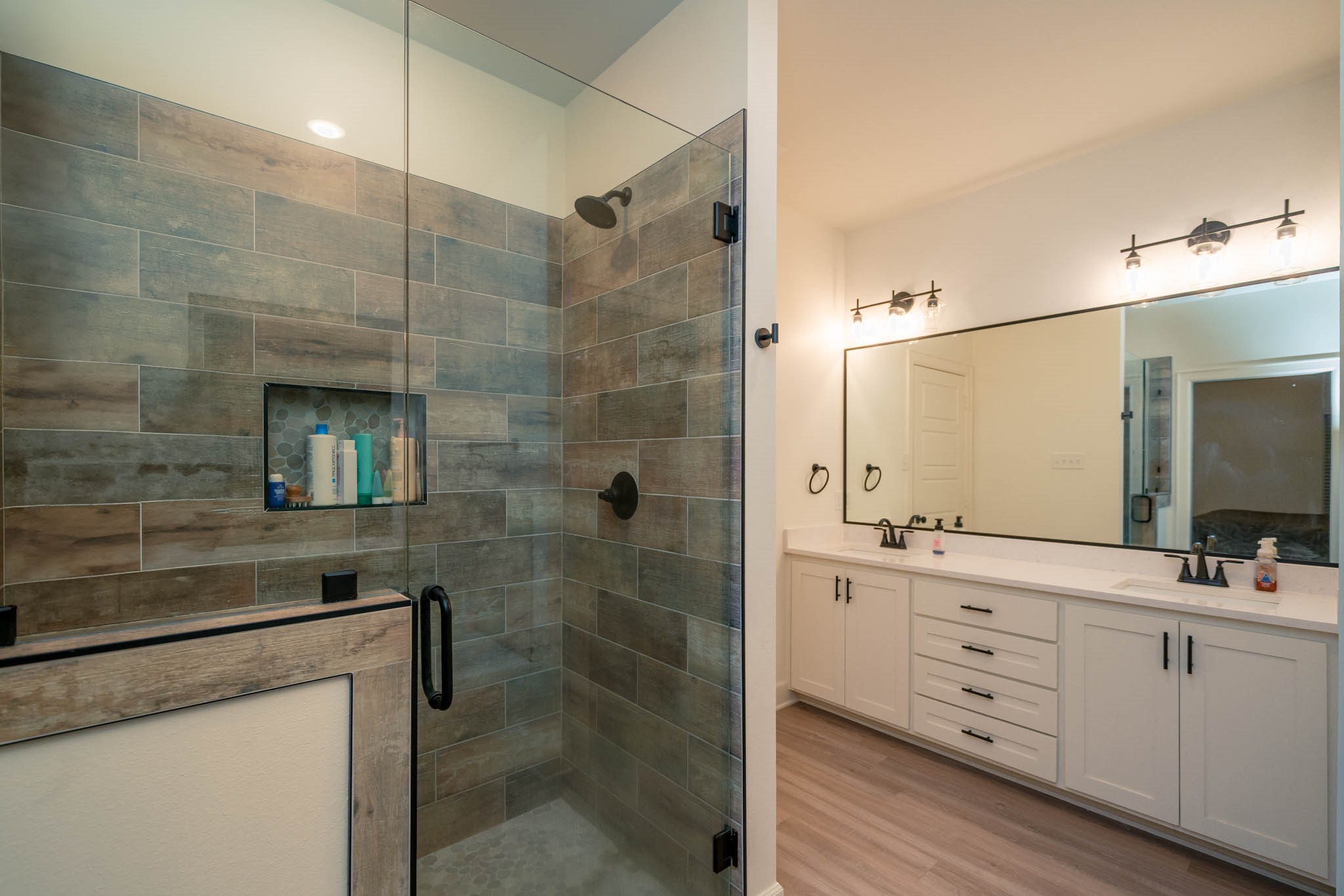 113 West Ruth Street White Oak, TX 75693 - Photo 17 of 27 a bathroom with a double vanity sink a toilet and shower