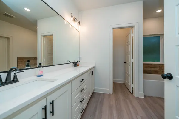 a bathroom with a double vanity sink and mirror