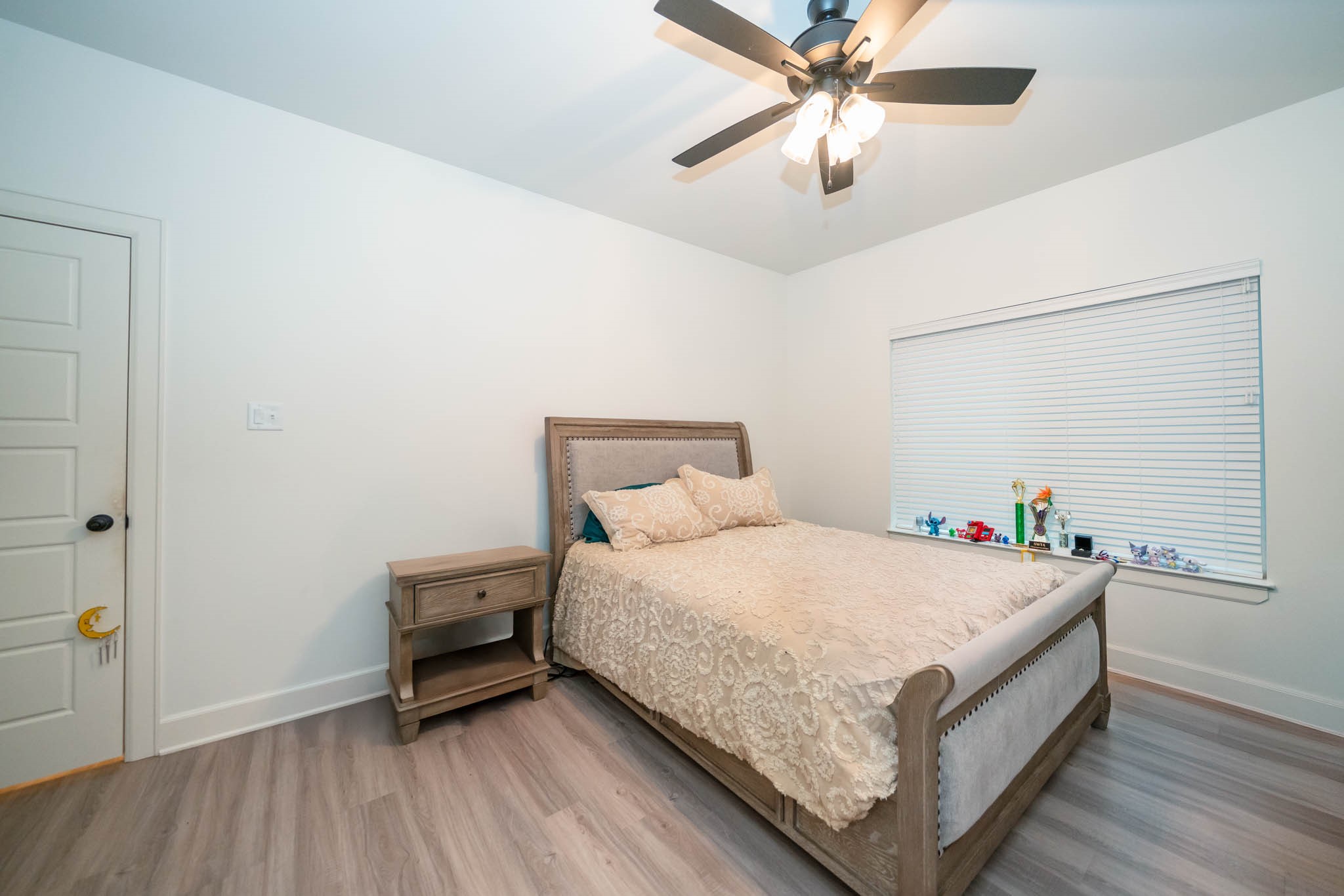 113 West Ruth Street White Oak, TX 75693 - Photo 20 of 27 a bedroom with a bed and a chandelier
