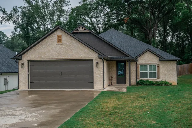 a view of a house with a yard and garage