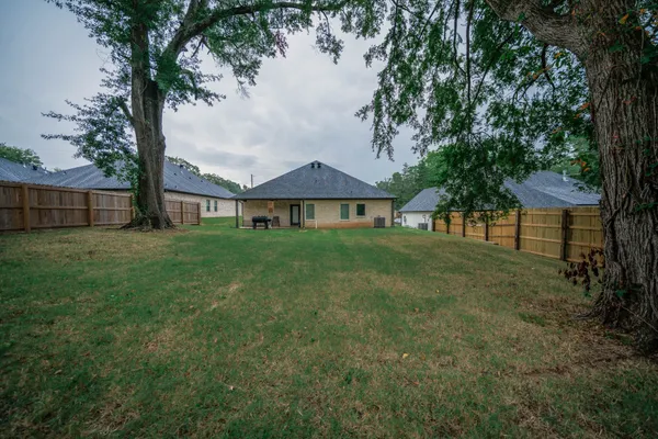 a view of a house with a yard and sitting area