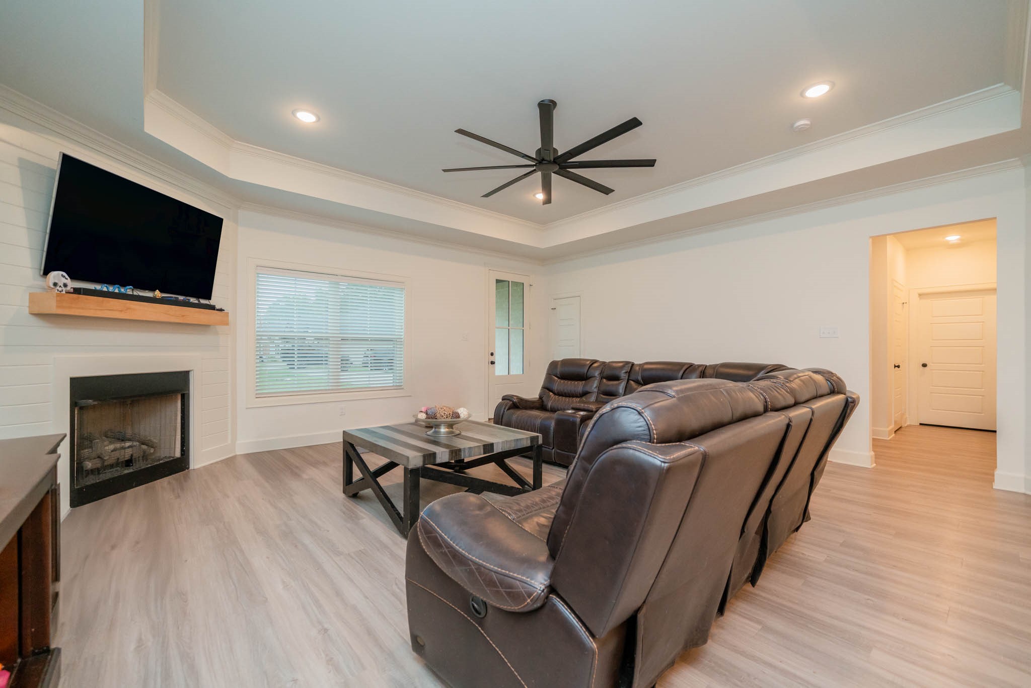 113 West Ruth Street White Oak, TX 75693 - Photo 5 of 27 a living room with furniture a fireplace and a flat screen tv