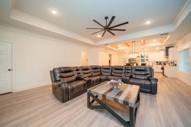 a living room with lots of furniture and wooden floor