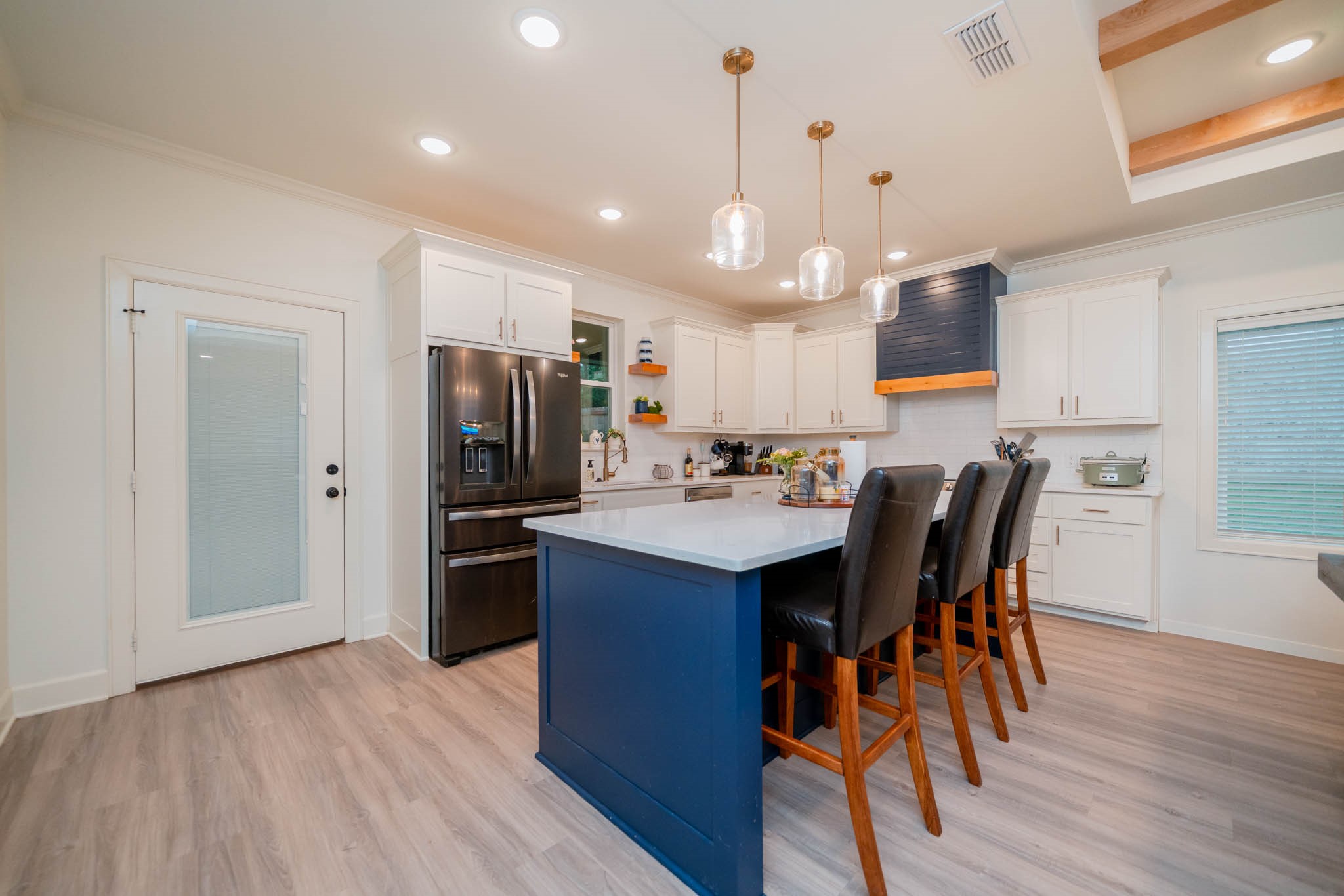 113 West Ruth Street White Oak, TX 75693 - Photo 8 of 27 a kitchen with stainless steel appliances kitchen island granite countertop a refrigerator a stove a sink dishwasher a dining table and chairs with wooden floor