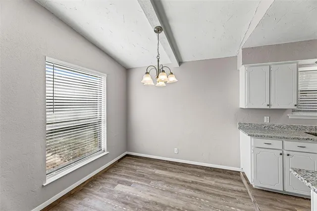 a kitchen with a refrigerator and a stove top oven