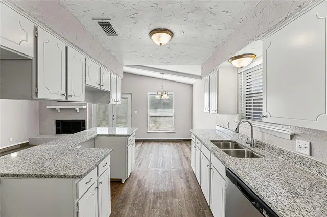 a kitchen with a sink cabinets and window
