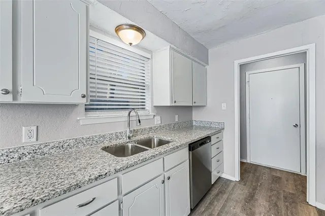 a kitchen with a sink cabinets and window