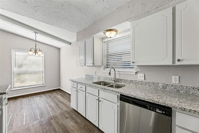 a kitchen with stainless steel appliances white cabinets and a sink