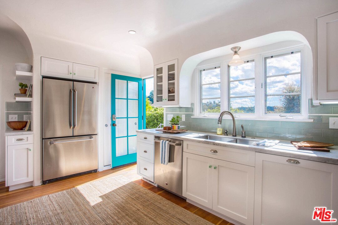 4541 Round Top Drive Los Angeles, CA 90065 - Photo 11 of 40 a kitchen with a refrigerator wooden floor a sink and a window