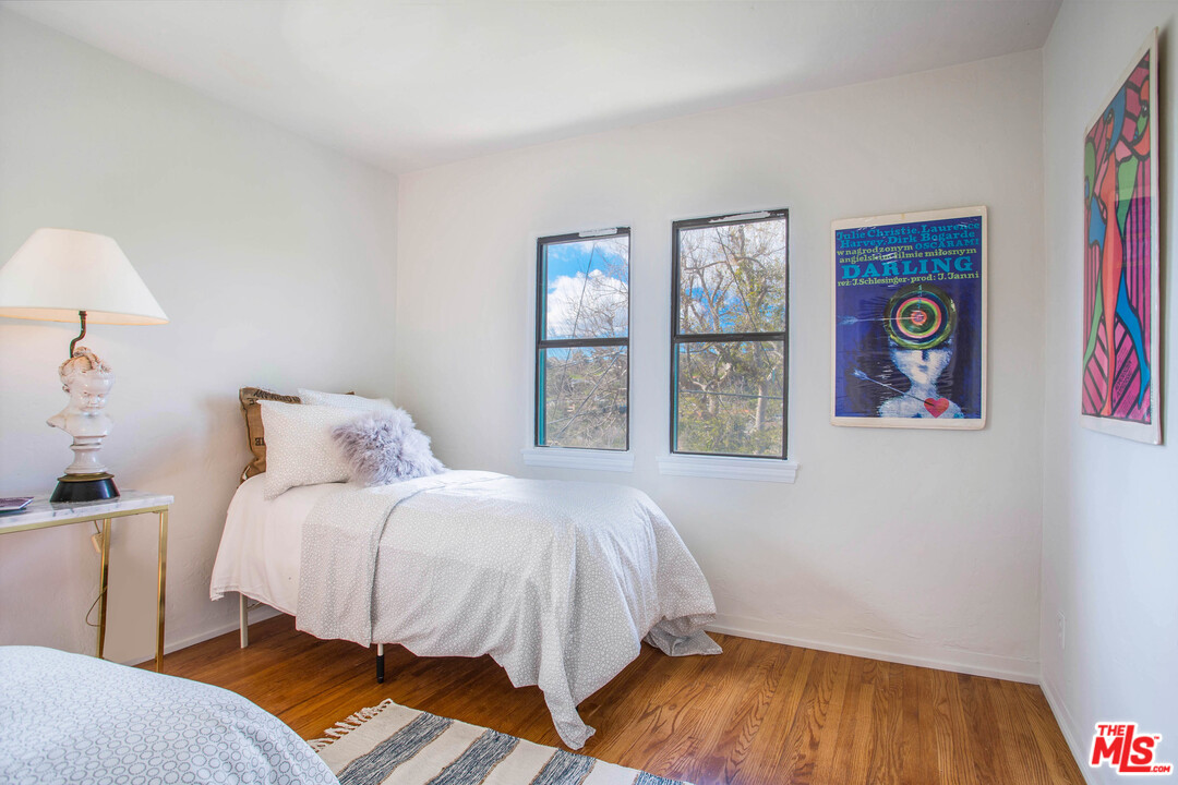 4541 Round Top Drive Los Angeles, CA 90065 - Photo 19 of 40 a bedroom with a bed and a lamp on dresser