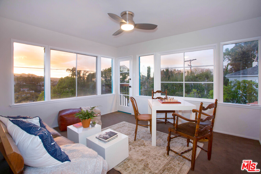 4541 Round Top Drive Los Angeles, CA 90065 - Photo 34 of 40 a dining room with furniture a chandelier and wooden floor