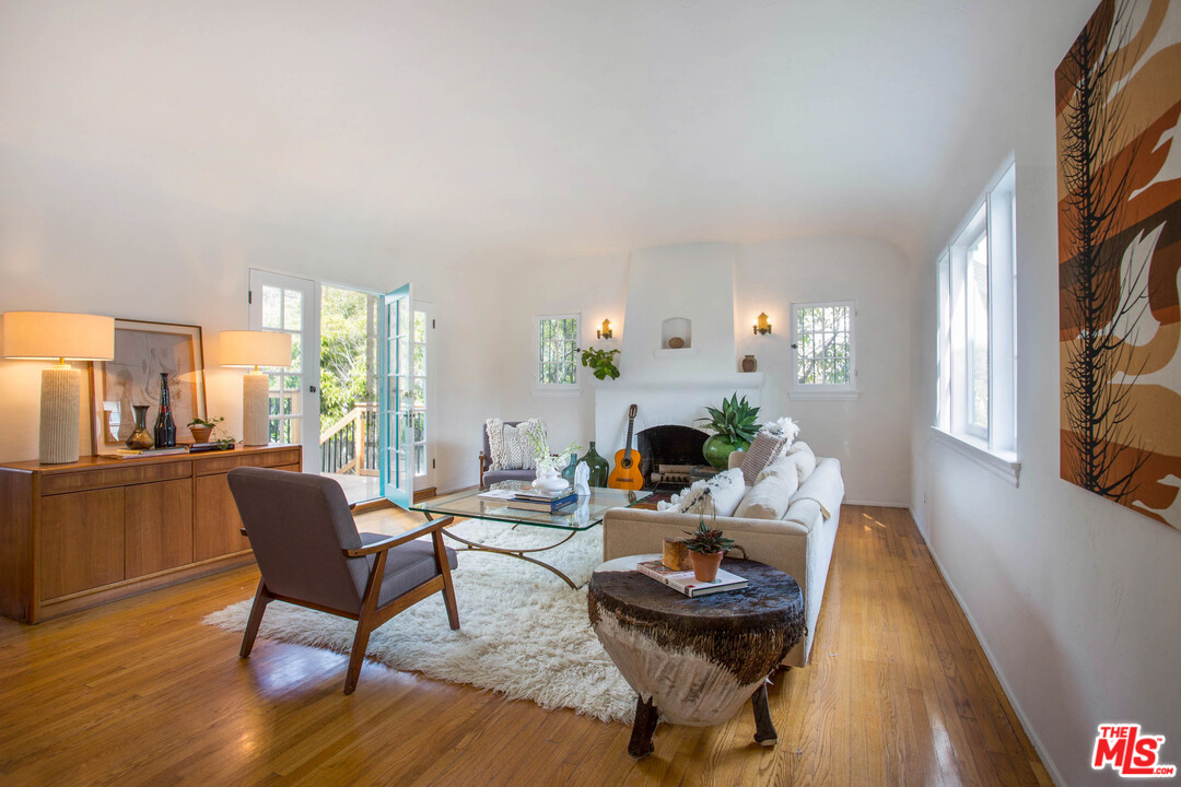 4541 Round Top Drive Los Angeles, CA 90065 - Photo 5 of 40 a living room with furniture a fireplace and a floor to ceiling window