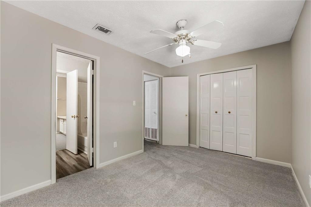 6170 Woodland Road Northwest Peachtree Corners, GA 30092 - Photo 15 of 27 a view of an empty room with a fan