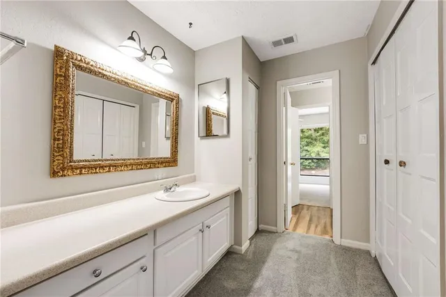 a spacious bathroom with a double vanity sink and a mirror