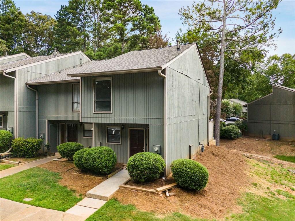 6170 Woodland Road Northwest Peachtree Corners, GA 30092 - Photo 2 of 27 a view of a house with a yard and plants