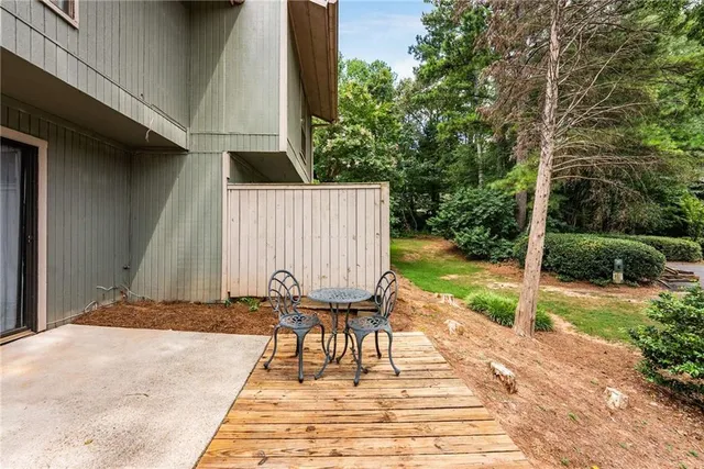 a view of backyard with wooden fence and trees