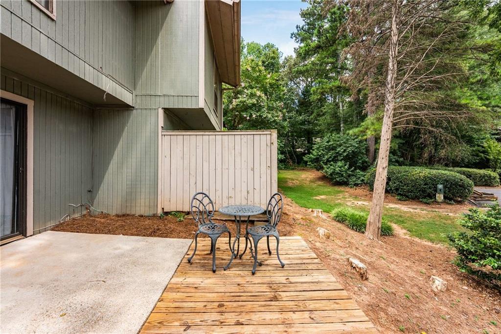 6170 Woodland Road Northwest Peachtree Corners, GA 30092 - Photo 21 of 27 a view of backyard with wooden fence and trees