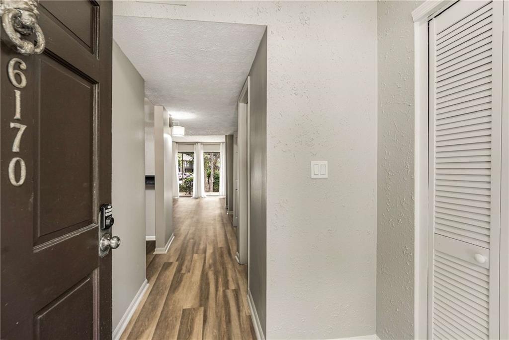 6170 Woodland Road Northwest Peachtree Corners, GA 30092 - Photo 4 of 27 a view of a hallway with wooden floor and staircase