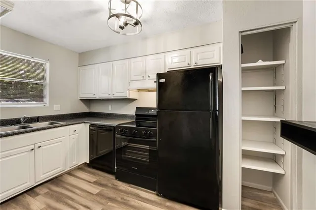a kitchen with a refrigerator and a sink