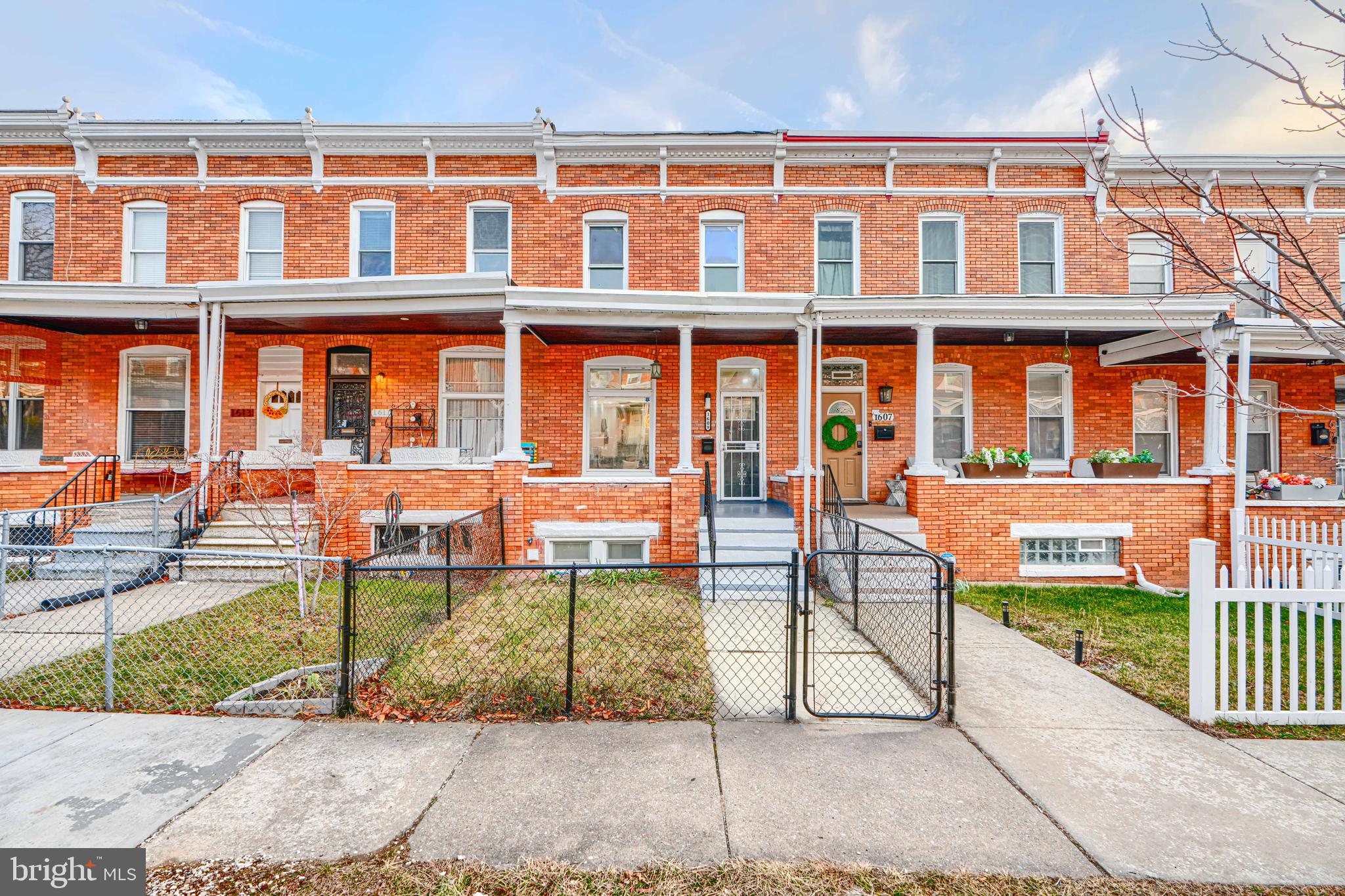 1609 East 30th Street Baltimore, MD 21218 - Photo 1 of 1 front view of a brick building with a yard