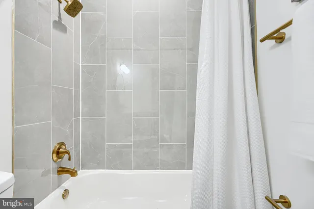 a bathroom with a bathtub and shower