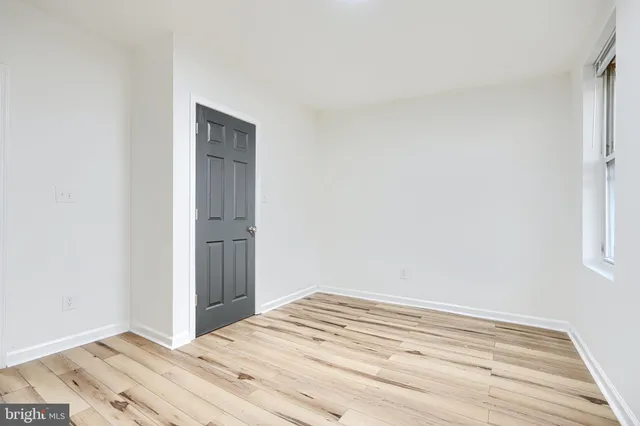 a view of a room with wooden floor and closet