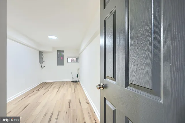 a view of empty room with wooden floor