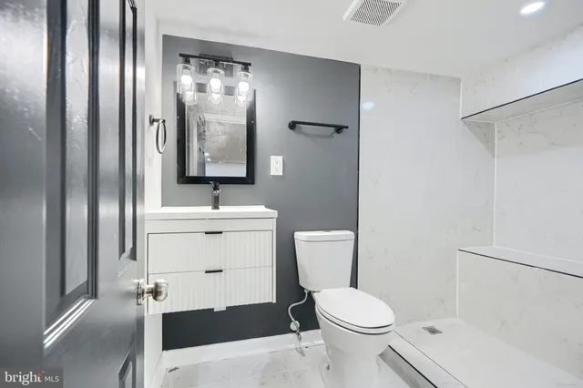 a bathroom with a toilet sink and shower