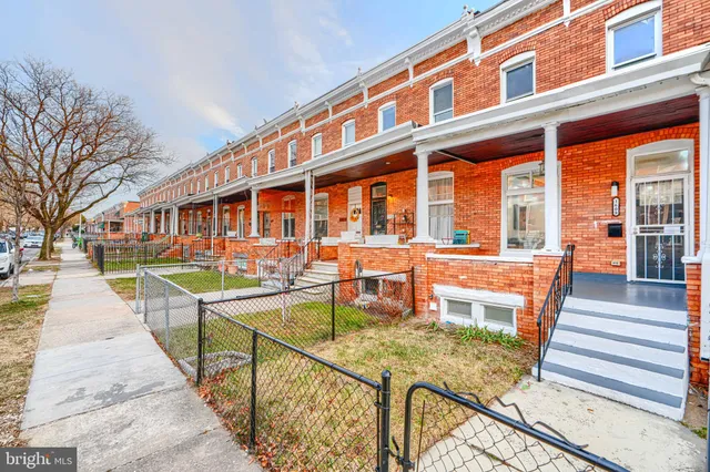 a view of a house with pool and chairs