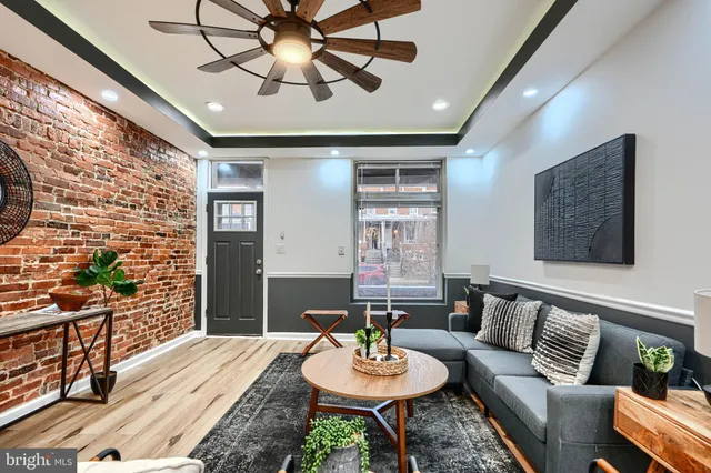 a living room with furniture and a wooden floor